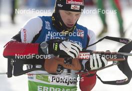 18.12.2010, Pokljuka, Slovenia (SLO): Dominik Landertinger (AUT), Fischer, Rottefella, Leki - IBU world cup biathlon, sprint men, Pokljuka (SLO). www.nordicfocus.com. © Miko/NordicFocus. Every downloaded picture is fee-liable.