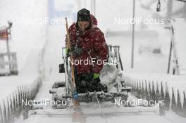 17.12.2010, Engelberg, Switzerland (SUI): Track marshall tries to clean the inrun prior to the qualification- FIS world cup ski jumping, replacing Harrachov, Engelberg (SUI). www.nordicfocus.com. © Manzoni/NordicFocus. Every downloaded picture is fee-liable.