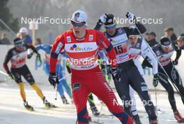15.01.2012, Milano, Italy (ITA): in front Anders Gloeersen (NOR), Fischer, Alpina, Rottefella, Swix behind Simeon Hamilton (USA), Fischer, Rottefella, Alpina, Swix  - FIS world cup cross-country, team sprint, Milano (ITA). www.nordicfocus.com. © Hemmersbach/NordicFocus. Every downloaded picture is fee-liable.