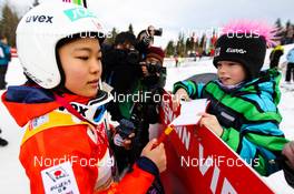 22.12.2013, Hinterzarten, Germany (GER): Sara Takanashi (JPN) writing autograms - FIS world cup ski jumping ladies, individual HS106, Hinterzarten (GER). www.nordicfocus.com. © Laiho/NordicFocus. Every downloaded picture is fee-liable.