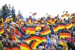 01.01.2024, Garmisch, Germany (GER): German spectators with their flag - FIS world cup ski jumping men, four hills tournament, individual HS142, Garmisch (GER). www.nordicfocus.com. © Reichert/NordicFocus. Every downloaded picture is fee-liable.