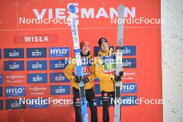 13.01.2024, Wisla, Poland (POL): Stephan Leyhe (GER), Andreas Wellinger (GER), (l-r) - FIS world cup ski jumping men, super team HS140, Wisla (POL). www.nordicfocus.com. © Reichert/NordicFocus. Every downloaded picture is fee-liable.