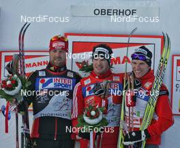 28.12.2008, Oberhof, Germany (GER): podium, l-r Axel Teichmann (GER), Madshus, Rottefella, Swix, adidas, Toko, Dario Cologna (SUI), Fischer, Rottefella, Alpina, Swix, adidas, Devon Kershaw (CAN), Fischer, Salomon, Swix  - FIS world cup cross-country, tour de ski, 15km men handicap start, Oberhof (GER). www.nordicfocus.com. © Hemmersbach/NordicFocus. Every downloaded picture is fee-liable.