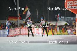 14.01.2009, Ruhpolding, Germany (GER): Magdalena Neuner (GER), Fischer, Rottefella, Exel, adidas and Kathrin Hitzer (GER), Fischer, Rottefella, Madshus, Leki, adidas - IBU world cup biathlon, relay women, Ruhpolding (GER). www.nordicfocus.com. © Manzoni/NordicFocus. Every downloaded picture is fee-liable.