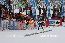 14.03.2009, Vancouver, Canada (CAN): Andrea Henkel (GER), Atomic, Exel, adidas, Toko grabs the flag - IBU world cup biathlon, relay women, Vancouver (CAN). www.nordicfocus.com. © Manzoni/NordicFocus. Every downloaded picture is fee-liable.