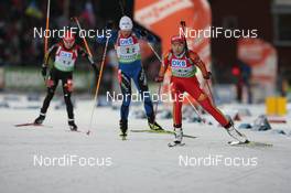06.12.2009, Oestersund, Sweden (SWE): Chaoqing Song (CHN), Fischer, Salomon, Swix, adidas, leads Sylvie Becaert (FRA), Fischer, Rottefella, Exel, Odlo and Andrea Henkel (GER), Atomic, Exel, adidas, Toko - IBU world cup biathlon, relay women, Oestersund (SWE). www.nordicfocus.com. © Manzoni/NordicFocus. Every downloaded picture is fee-liable.
