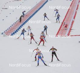 21.02.2009, Liberec, Czech Republic (CZE): feature, change of ski, in front Arianna Follis (ITA), Fischer, Salomon, Swix, behind Therese Johaug (NOR), Fischer, Salomon, Swix and Evi Sachenbacher Stehle (GER), Madshus, Rottefella, Leki, adidas - FIS nordic world ski championships, cross-country, pursuit women, Liberec (CZE). www.nordicfocus.com. © Hemmersbach/NordicFocus. Every downloaded picture is fee-liable.