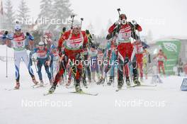 12.12.2010, Hochfilzen, Austria (AUT): Alexander Os (NOR), Fischer, Rottefella, Swix, Odlo, Daniel Mesotitsch (AUT), Fischer, Rottefella, Leki - IBU world cup biathlon, relay men, Hochfilzen (AUT). www.nordicfocus.com. © Manzoni/NordicFocus. Every downloaded picture is fee-liable.