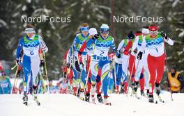 27.02.2010, Whistler, Canada (CAN): l-r: Marianna Longa (ITA), Fischer, Salomon, One Way, Aino Kaisa Saarinen (FIN), Rossignol, Rottefella, One Way, Justyna Kowalczyk (POL), Fischer, Salomon, Swix, leading after the start - Olympic Winter Games Vancouver 2010, cross-country, mass women, Whistler (CAN). www.nordicfocus.com. © NordicFocus. Every downloaded picture is fee-liable.