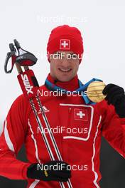 23.02.2010, Whistler, Canada (CAN): medal, Dario Cologna (SUI), Fischer, Rottefella, Alpina, Swix, adidas  - Olympic Winter Games Vancouver 2010, cross-country, medals, Whistler (CAN). www.nordicfocus.com. © NordicFocus. Every downloaded picture is fee-liable.