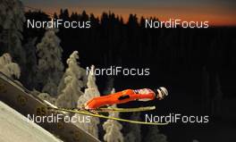 27.11.2010, Kuusamo, Finland (FIN): Ski jumper flying down in the dawn over Kuusamo - FIS world cup ski jumping, team HS142, Kuusamo (FIN). www.nordicfocus.com. Â© Felgenhauer/NordicFocus. Every downloaded picture is fee-liable.
