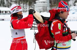 13.03.2011, Lahti, Finland (FIN): (l-r) Marit Bjoergen (NOR), Fischer, Swix, Rottefella puts her price into the trainer´s back pack  - FIS world cup cross-country, individual sprint, Lahti (FIN). www.nordicfocus.com. © Laiho/NordicFocus. Every downloaded picture is fee-liable.