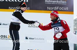 01.03.2011, Oslo, Norway (NOR):  (r-l) Martin Jonsrud Sundby (NOR), Fischer, KV+, Alpina, Rottefella, Swix congratulates the winner Matti Heikkinen (FIN), Fischer, Exel, Alpina, Rottefella, Craft - FIS nordic world ski championships, cross-country, 15km men, Oslo (NOR). www.nordicfocus.com. © Laiho/NordicFocus. Every downloaded picture is fee-liable.