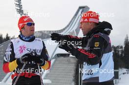 21.02.2011, Oslo, Norway (NOR): l-r: Kuno Schreyl (GER), Headcoach Men, Team Germany explains Hannes Dotzler (GER), Fischer, Rottefella, Swix, Adidas the competition track - FIS nordic world ski championships, cross-country, training, Oslo (NOR). www.nordicfocus.com. © Hemmersbach/NordicFocus. Every downloaded picture is fee-liable.
