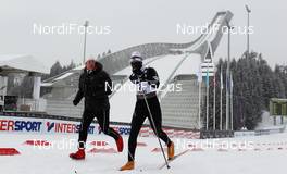 23.02.2011, Oslo, Norway (NOR):  (l-r) the ski legend Bjoern Daehlie running beside Philip Boit (KEN) - FIS nordic world ski championships, cross-country, Individual Classic Qualification Race, Oslo (NOR). www.nordicfocus.com. © Laiho/NordicFocus. Every downloaded picture is fee-liable.