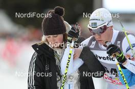 10.12.2011, Davos, Switzerland (SUI): Melanie Angerer (SUI), press officer Davos Nordic and Anton Lindblad (SWE), Madshus, Rottefella, Alpina, OneWay - FIS world cup cross-country, 30km men, Davos (SUI). www.nordicfocus.com. © Manzoni/NordicFocus. Every downloaded picture is fee-liable.
