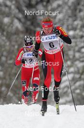 17.12.2011, Rogla, Slovenia (SLO): in front Justyna Kowalczyk (POL), Fischer, Rottefella, Swix, behind Therese Johaug (NOR), Fischer, Salomon, Swix  - FIS world cup cross-country, mass women, Rogla (SLO). www.nordicfocus.com. © Hemmersbach/NordicFocus. Every downloaded picture is fee-liable.