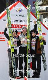 20.03.2011, Planica, Slovenia (SLO): Ski Jumping Overall World Cup Podium, l-r: 2nd Simon Ammann (SUI), Fischer, 1st Thomas Morgenstern (AUT), Fischer, 3rd Adam Malysz (POL), Fischer  - FIS world cup ski jumping final, cups, Planica (SLO). www.nordicfocus.com. © Hemmersbach/NordicFocus. Every downloaded picture is fee-liable.