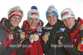 27.02.2011, Oslo, Norway (NOR): Gold Medal Team; Team Austria, l-r: Thomas Morgenstern, Andreas Kofler, Gregor Schlierenzauer, Martin Koch - FIS nordic world ski championships, ski jumping, medals, Oslo (NOR). www.nordicfocus.com. © Hemmersbach/NordicFocus. Every downloaded picture is fee-liable.