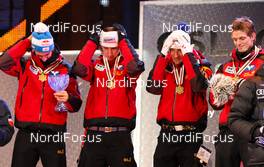 27.02.2011, Oslo, Norway (NOR):  permission to wear hats again after national anthem, the winner team, Austria, (l-r) Gregor Schlierenzauer (AUT), Fischer, Martin Koch (AUT), Fischer, Andreas Kofler (AUT), Fischer and Thomas Morgenstern (AUT), Fischer  - FIS nordic world ski championships, ski jumping, team HS106, Oslo (NOR). www.nordicfocus.com. © Laiho/NordicFocus. Every downloaded picture is fee-liable.