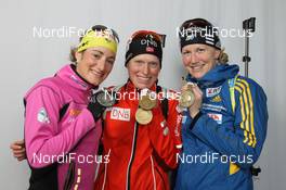 07.03.2012, Ruhpolding, Germany (GER): L-R: Marie Laure Brunet (FRA), Rossignol, Rottefella, Swix, Tora Berger (NOR), Fischer, Rottefella, Odlo, Helena Ekholm (SWE), Fischer, Rottefella, Leki, adidas - IBU world championships biathlon, medals, Ruhpolding (GER). www.nordicfocus.com. © Manzoni/NordicFocus. Every downloaded picture is fee-liable.