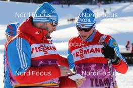 07.01.2012, Val di Fiemme, Italy (ITA): l-r: Urmas Vaelbe (EST), ski man Team Russia and Reto Burgermeister (SUI), Team Russia - FIS world cup cross-country, tour de ski, mass men, Val di Fiemme (ITA). www.nordicfocus.com. © Hemmersbach/NordicFocus. Every downloaded picture is fee-liable.
