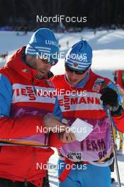 07.01.2012, Val di Fiemme, Italy (ITA): l-r: Urmas Vaelbe (EST), ski man Team Russia and Reto Burgermeister (SUI), Team Russia - FIS world cup cross-country, tour de ski, mass men, Val di Fiemme (ITA). www.nordicfocus.com. © Hemmersbach/NordicFocus. Every downloaded picture is fee-liable.