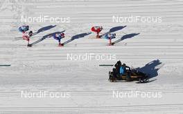 07.01.2012, Val di Fiemme, Italy (ITA): Helicopter view: in front Maxim Vylegzhanin (RUS), Fischer, Rottefella, Alpina, Swix, adidas, behind Petter Northug (NOR), Fischer, Rottefella, Alpina, Ski Go, Swix, Lukas Bauer (CZE), Fischer, Rottefella, Alpina, Swix, Toko, Alex Harvey (CAN), Fischer, Salomon, Swix, One Way, Alexander Legkov (RUS), Rossignol, Rottefella, Swix, adidas  - FIS world cup cross-country, tour de ski, mass men, Val di Fiemme (ITA). www.nordicfocus.com. © Hemmersbach/NordicFocus. Every downloaded picture is fee-liable.