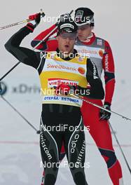21.01.2012, Otepaeae, Estland (EST): todays winner Dario Cologna (SUI), Fischer, Rottefella, Alpina, Swix, Odlo, behind Ola Vigen Hattestad (NOR), Fischer, Rottefella, Swix  - FIS world cup cross-country, individual sprint, Otepaeae (EST). www.nordicfocus.com. © Hemmersbach/NordicFocus. Every downloaded picture is fee-liable.