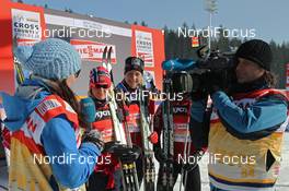 12.02.2012, Nove Mesto, Czech Republic (CZE): Ida Nysaeter Rasch (NOR), NRK interviews the winning team Norway I, in the background, l-r: Therese Johaug (NOR), Fischer, Salomon, Swix and Astrid Uhrenholdt Jacobsen (NOR), Fischer, Rottefella, Swix  - FIS world cup cross-country, 4x5km women, Nove Mesto (CZE). www.nordicfocus.com. © Hemmersbach/NordicFocus. Every downloaded picture is fee-liable.