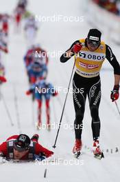10.03.2012, Oslo, Norway (NOR): finish, l-r: Eldar Roenning (NOR), Rossignol, Rottefella, Swix and Dario Cologna (SUI), Fischer, Rottefella, Alpina, Swix, Odlo  - FIS world cup cross-country, mass men, Oslo (NOR). www.nordicfocus.com. © Hemmersbach/NordicFocus. Every downloaded picture is fee-liable.