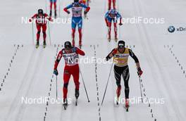 10.03.2012, Oslo, Norway (NOR): (l-r) Eldar Roenning (NOR), Rorrignol, Swix, Rottefella and Dario Cologna (SUI), Fischer, Swix, Alpina, Rottefella, Odlo  - FIS world cup cross-country, mass men, Oslo (NOR). www.nordicfocus.com. Â© Laiho/NordicFocus. Every downloaded picture is fee-liable.
