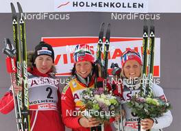 11.03.2012, Oslo, Norway (NOR): podium, l-r: Justyna Kowalczyk (POL), Fischer, Rottefella, Swix, Marit Bjoergen (NOR), Fischer, Rottefella, Swix, Therese Johaug (NOR), Fischer, Salomon, Swix  - FIS world cup cross-country, mass women, Oslo (NOR). www.nordicfocus.com. © Hemmersbach/NordicFocus. Every downloaded picture is fee-liable.