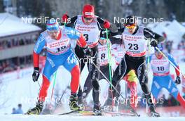 15.12.2012, Canmore, Canada (CAN):  Alexey Petukhov (RUS), Fischer, Swix, Rottefella, Adidas followed by Jovian Hediger (SUI), Rossignol, KV+, Rottefella, Odlo and Martin Jaeger (SUI), Rossignol, One Way, Rottefella, Odlo - FIS world cup cross-country, individual sprint, Canmore (CAN). www.nordicfocus.com. © Roycroft/NordicFocus. Every downloaded picture is fee-liable.
