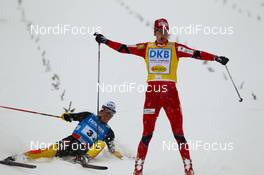 07.01.2012, Oberstdorf, Germany (GER): (r-l)  Joergen Graabak (NOR), Fischer  celebrates the victory and Tino Edelmann (GER), Madshus, Leki, Rottefella, Adidas lies on the snow after the finish line - FIS world cup nordic combined, team HS106/4x5km, Oberstdorf (GER). www.nordicfocus.com. Â© Laiho/NordicFocus. Every downloaded picture is fee-liable.