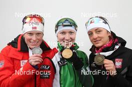 17.02.2013, Nove Mesto, Czech Republic (CZE): L-R: Tora Berger (NOR), Fischer, Rottefella, Odlo, Darya Domracheva (BLR), Fischer, Rottefella, Leki, Monika Hojnisz (POL), Fischer, Rottefella, Alpina, Leki, Casco - IBU world championships biathlon, medals, Nove Mesto (CZE). www.nordicfocus.com. © Manzoni/NordicFocus. Every downloaded picture is fee-liable.