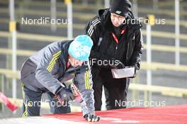 27.11.2013, Oestersund, Sweden (SWE): Biathlon Feature: Volunteers try to fix the shooting mats - IBU world cup biathlon, individual women, Oestersund (SWE). www.nordicfocus.com. © Manzoni/NordicFocus. Every downloaded picture is fee-liable.