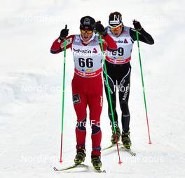 17.02.2013, Davos, Switzerland (SUI): l-r:  Martin Johnsrud Sundby (NOR), Erwan Kaeser (SUI) - FIS world cup cross-country, 15km men, Davos (SUI). www.nordicfocus.com. © Felgenhauer/NordicFocus. Every downloaded picture is fee-liable.