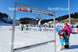 10.03.2013, Lahti, Finland (FIN): the autograph board at the start and two volunteers - FIS world cup cross-country, 15km men, Lahti (FIN). www.nordicfocus.com. © Laiho/NordicFocus. Every downloaded picture is fee-liable.
