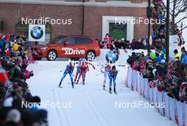 13.03.2013, Drammen, Norway (NOR): a group of skiers passing a BMW sponsor car - FIS world cup cross-country, individual sprint, Drammen (NOR). www.nordicfocus.com. © Laiho/NordicFocus. Every downloaded picture is fee-liable.