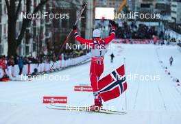 13.03.2013, Drammen, Norway (NOR): Petter Northug (NOR), Fischer, Swix, Alpina, Rottefella sets a norwegian flag onto the finnish line - FIS world cup cross-country, individual sprint, Drammen (NOR). www.nordicfocus.com. © Laiho/NordicFocus. Every downloaded picture is fee-liable.