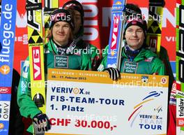 17.02.2013, Oberstdorf, Germany (GER): (l-r) Tom Hilde (NOR), Fischer and Anders Jacobsen (NOR), Fluege.de with the victory check  - FIS world cup ski flying, team HS213, Oberstdorf (GER). www.nordicfocus.com. © Laiho/NordicFocus. Every downloaded picture is fee-liable.