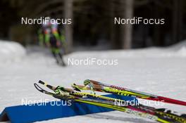 06.03.2014, Pokljuka, Slovenia (SLO): Event Feature: Spare skis and poles with a competing athlete in the back - IBU world cup biathlon, sprint men, Pokljuka (SLO). www.nordicfocus.com. © Manzoni/NordicFocus. Every downloaded picture is fee-liable.