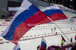22.02.2014, Sochi, Russia (RUS): Event Feature: Russian flags with Athletes competing on the track - XXII. Olympic Winter Games Sochi 2014, biathlon, relay men, Sochi (RUS). www.nordicfocus.com. © NordicFocus. Every downloaded picture is fee-liable.