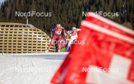 21.12.2014, Davos, Switzerland (SUI): (l-r) Maiken Caspersen Falla (NOR), Fischer, Swix, Rottefella  and Stina Nilsson (SWE), Fischer, Alpina, Craft behind the swiss flags - FIS world cup cross-country, individual sprint, Davos (SUI). www.nordicfocus.com. © Laiho/NordicFocus. Every downloaded picture is fee-liable.
