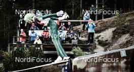 20.12.2014, Ramsau, Austria (AUT):  ski jumper in front of coaches - FIS world cup nordic combined, team sprint HS98/2x7.5km, Ramsau (AUT). www.nordicfocus.com. © Felgenhauer/NordicFocus. Every downloaded picture is fee-liable.
