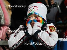 11.02.2014, Sochi, Russia (RUS): a bored boy with Sochi gloves and hat - XXII. Olympic Winter Games Sochi 2014, ski jumping ladies, individual HS106, Sochi (RUS). www.nordicfocus.com. © NordicFocus. Every downloaded picture is fee-liable.