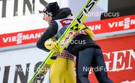 04.01.2015, Innsbruck, Austria (AUT): (l-r) Noriaki Kasai (JPN), Fischer hugged by Simon Ammann (SUI), Fischer - FIS world cup ski jumping, four hills tournament, individual HS130, Innsbruck (AUT). www.nordicfocus.com. © Laiho/NordicFocus. Every downloaded picture is fee-liable.