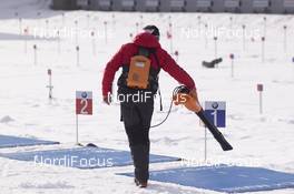 18.02.2017, Hochfilzen, Austria (AUT): Event Feature: Volunteer cleans the shooting mats - IBU world championships biathlon, relay men, Hochfilzen (AUT). www.nordicfocus.com. © NordicFocus. Every downloaded picture is fee-liable.