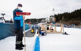 10.03.2021, Nove Mesto, Czech Republic (CZE): Event Feature: shooting range volunteer waits with the brush - IBU World Cup Biathlon, training, Nove Mesto (CZE). www.nordicfocus.com. © Manzoni/NordicFocus. Every downloaded picture is fee-liable.